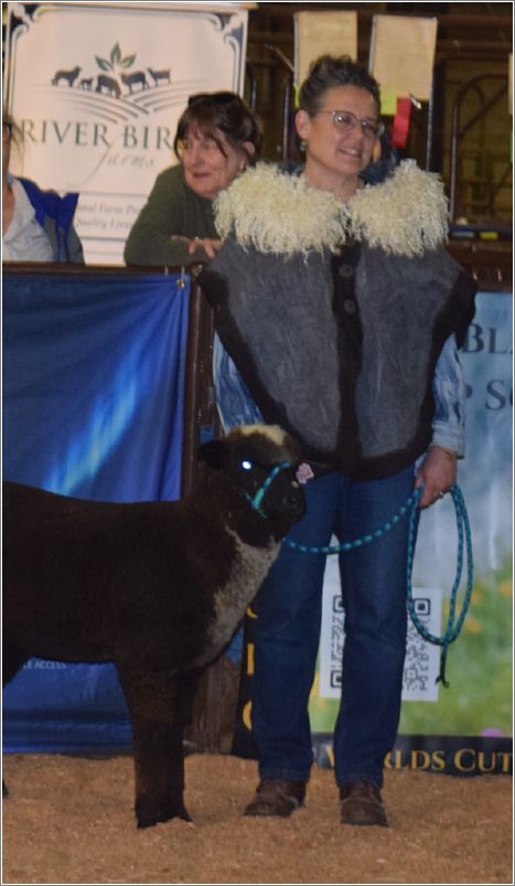 Teresa Beatty models her wet- and needle-felted cape that was awarded Fiber Arts Best Quality of Felting Entry. She wet-felted Merino with a Corriedale border and needle-felted Teeswater locks in to the collar. Clay buttons hand made by Mud Buttons. Photo: Peggy Lundquist.